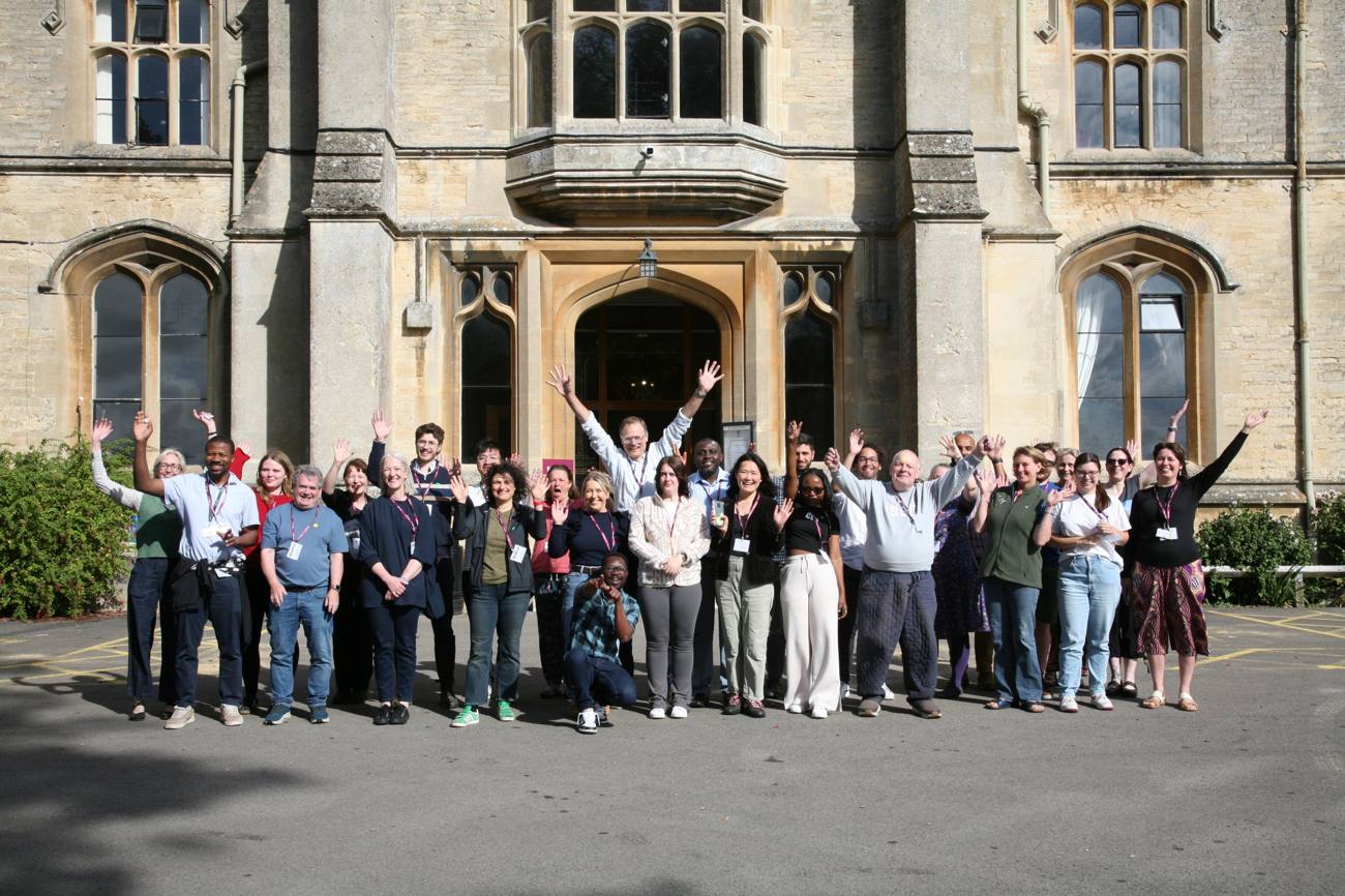 Bridging Fields participants waving outside the RAU main building